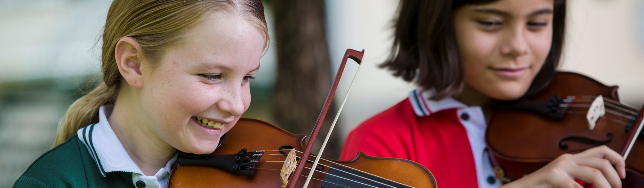 Two female students playing violins