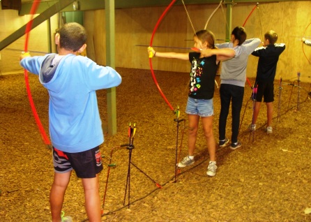 Four students doing archery