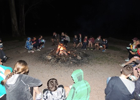 Students in circle around campfire