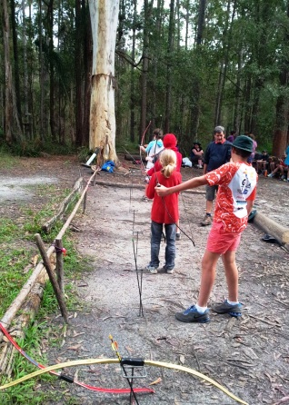 Students shooting bows and arrows