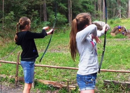 Girls shooting bows and arrows