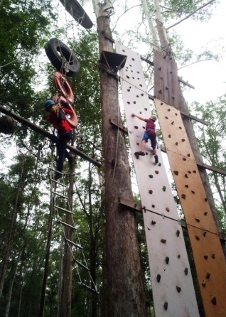 Student climbing on vertical wall